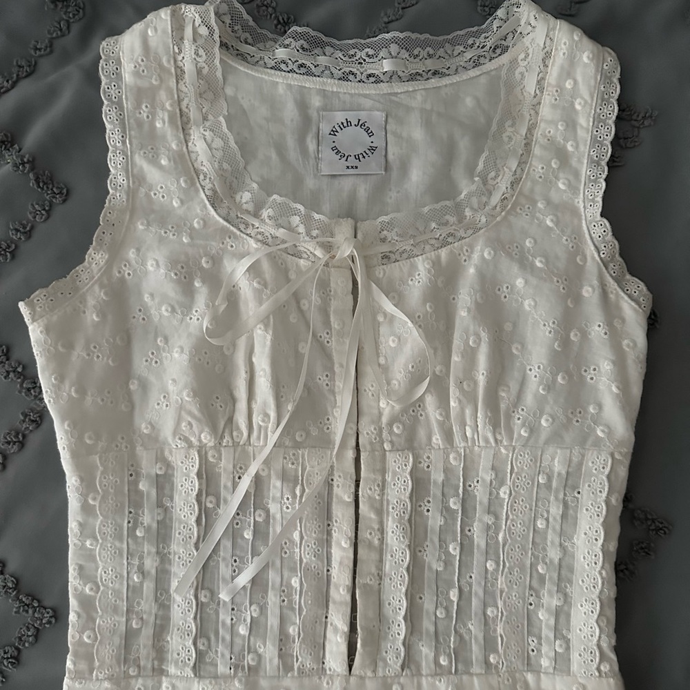 With Jèan white dress adjustable in the back. Worn once
